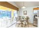 Kitchen dining area with glass table, chairs, and view of pool area at 8458 Secret Key Cove, Kissimmee, FL 34747