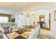 Spacious dining area with a large table, and views into the living room and entry way at 8458 Secret Key Cove, Kissimmee, FL 34747