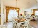 Bright dining room features a large table with seating for eight and a lovely chandelier at 8458 Secret Key Cove, Kissimmee, FL 34747