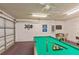 Game room features a pool table, dartboard, and TV at 8458 Secret Key Cove, Kissimmee, FL 34747