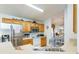 Modern kitchen with stainless steel appliances and light wood cabinetry at 8458 Secret Key Cove, Kissimmee, FL 34747