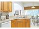 Kitchen features light wood cabinets, double sink, and views into the Gathering room at 8458 Secret Key Cove, Kissimmee, FL 34747
