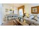 Living room with beige sofas, coffee table, and view into dining area at 8458 Secret Key Cove, Kissimmee, FL 34747