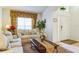 Living room with beige sofas, coffee table, and view of the entryway at 8458 Secret Key Cove, Kissimmee, FL 34747