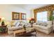 Living room with two beige sofas, coffee table, and decorative accents at 8458 Secret Key Cove, Kissimmee, FL 34747