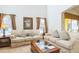 Relaxing living room with comfortable sofas, a coffee table, and neutral decor at 8458 Secret Key Cove, Kissimmee, FL 34747