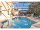 Refreshing pool with a screened enclosure, perfect for sunny days at 8458 Secret Key Cove, Kissimmee, FL 34747