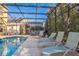 Relaxing pool and spa with covered patio and lounge chairs at 8458 Secret Key Cove, Kissimmee, FL 34747
