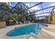 Inviting pool with screened enclosure, hot tub, and grill at 8458 Secret Key Cove, Kissimmee, FL 34747