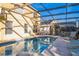 Inviting pool area with covered lanai, lounge chairs, and hot tub at 8458 Secret Key Cove, Kissimmee, FL 34747