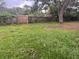 Large backyard with wooden fence at 100 S Ortman Dr, Orlando, FL 32805