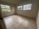 Bedroom with tile floors and two windows at 100 S Ortman Dr, Orlando, FL 32805