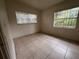 Bedroom with tile floors and two windows at 100 S Ortman Dr, Orlando, FL 32805