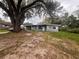 Gray house with a large tree in the front yard at 100 S Ortman Dr, Orlando, FL 32805