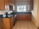 Kitchen with wood cabinets and stainless steel appliances at 100 S Ortman Dr, Orlando, FL 32805