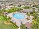 Community pool area with surrounding landscape and cabanas at 12420 Turtle Grass Dr, Orlando, FL 32824
