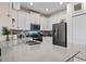 Modern kitchen with white cabinets, stainless steel appliances, and granite countertops at 12420 Turtle Grass Dr, Orlando, FL 32824