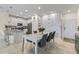 Bright eat-in kitchen with white cabinets, kitchen island, and dining area at 12420 Turtle Grass Dr, Orlando, FL 32824