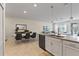 Open concept kitchen and dining area with white cabinets and an island at 12420 Turtle Grass Dr, Orlando, FL 32824