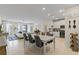 Open floor plan with white cabinets, kitchen island, and dining table at 12420 Turtle Grass Dr, Orlando, FL 32824