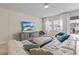 Living area with sectional sofa, large TV, and gray accent wall at 12420 Turtle Grass Dr, Orlando, FL 32824