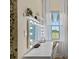 Stylish vanity area with large mirror and window at 12420 Turtle Grass Dr, Orlando, FL 32824