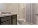 Small bathroom with shower and dark vanity at 1245 Limbali St, Mount Dora, FL 32757