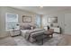 Bright bedroom with a comfortable bed and neutral decor at 1245 Limbali St, Mount Dora, FL 32757