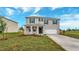 Two-story house with gray siding, dark shutters, and a white garage door at 1245 Limbali St, Mount Dora, FL 32757