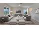 Living room with gray and white furniture, and a large TV at 1245 Limbali St, Mount Dora, FL 32757