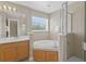 Bathroom with double vanity, shower, and tub at 128 Higher Combe Dr, Davenport, FL 33897