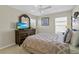 Bedroom with dresser, tv, and comfortable bed at 128 Higher Combe Dr, Davenport, FL 33897
