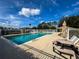 Relax by the refreshing community pool with lounge chairs and picnic tables at 128 Higher Combe Dr, Davenport, FL 33897