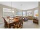 Spacious dining area with large windows and adjacent living room at 128 Higher Combe Dr, Davenport, FL 33897