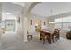 Formal dining room with wood table and chairs, view into kitchen at 128 Higher Combe Dr, Davenport, FL 33897