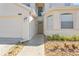 Two-story home's exterior with walkway and landscaping at 128 Higher Combe Dr, Davenport, FL 33897