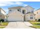Two-story house with a two-car garage at 128 Higher Combe Dr, Davenport, FL 33897