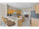 Eat-in kitchen with breakfast bar, wood cabinets, and island at 128 Higher Combe Dr, Davenport, FL 33897
