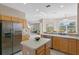 Open kitchen boasting stainless steel fridge and ample counter space at 128 Higher Combe Dr, Davenport, FL 33897