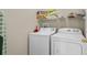 Laundry room with washer, dryer, and shelving at 128 Higher Combe Dr, Davenport, FL 33897