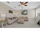 Comfortable living room with sofas, ottoman, and ceiling fan at 128 Higher Combe Dr, Davenport, FL 33897