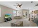 Relaxing living room featuring neutral colors and comfy sofas at 128 Higher Combe Dr, Davenport, FL 33897