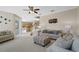 Spacious living room with two sofas, a ceiling fan, and large artwork at 128 Higher Combe Dr, Davenport, FL 33897