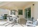 Outdoor patio with seating area, grill, and sliding glass doors at 128 Higher Combe Dr, Davenport, FL 33897