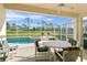 Relaxing screened-in pool area with patio furniture at 128 Higher Combe Dr, Davenport, FL 33897