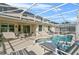 Large screened-in pool and spa with patio furniture at 128 Higher Combe Dr, Davenport, FL 33897
