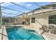 Inviting pool and spa with plenty of lounge chairs at 128 Higher Combe Dr, Davenport, FL 33897