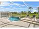 Relaxing screened pool area with lounge chairs and view of the golf course at 128 Higher Combe Dr, Davenport, FL 33897