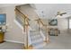 Elegant staircase with wood railing and carpeted steps at 128 Higher Combe Dr, Davenport, FL 33897