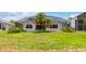 Screened pool and patio with grassy yard at 1748 Golfview Dr, Kissimmee, FL 34746